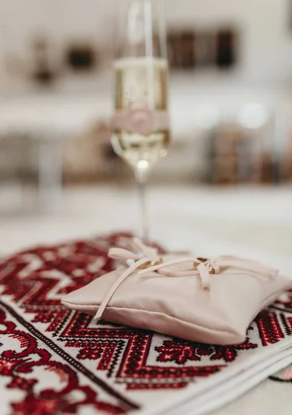 a glass of champagne for brides on an embroidered towel