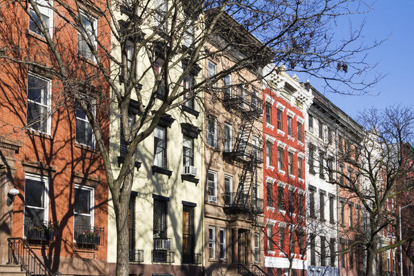 Colorful block of historic buildings along Tompkins Square Park on a bright sunny day in New York City