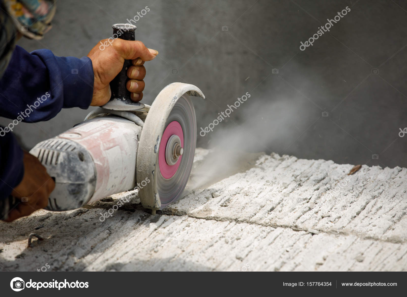 Worker using tool to cut concrete floor — Stock Photo © Surabky 157764354