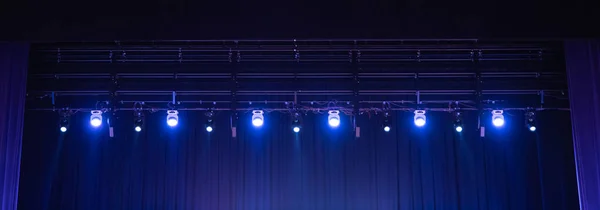 Row of colorful light set of concert stage on black background.