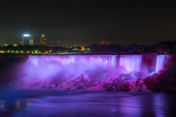 Niagara Falls lit at night by colorful lights — Stock Photo, Image