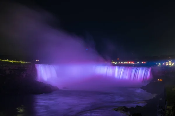 Niagara Falls lit at night by colorful lights — Stock Photo, Image