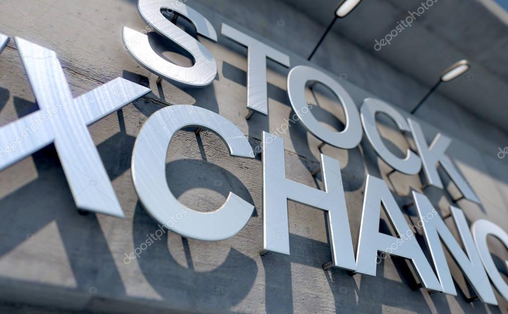 A 3D render of laser cut signage above the entrance to a modern generic stock exchange building composed of exposed concrete in the day time