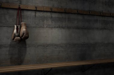Worn Vintage Boxing Gloves Hanging In Change Room clipart