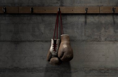 Worn Vintage Boxing Gloves Hanging In Change Room clipart