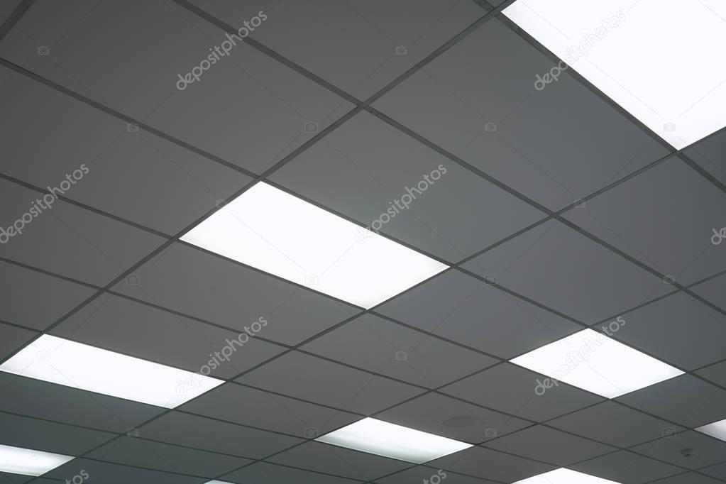 White ceiling with neon light bulbs in uprisen view.as background interior decoration concept with copy space for your text or design.