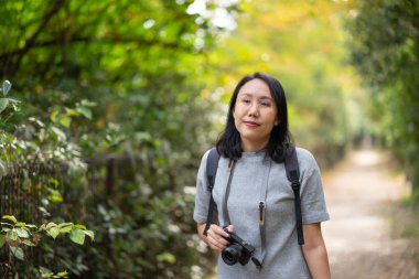 Profesyonel fotoğraf makinesi olan genç ve güzel bir fotoğrafçı.