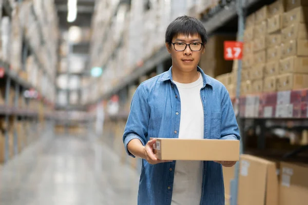 Portrait Asian men, staff, product counting Warehouse Control Manager Standing, counting and inspecting products in the warehouse