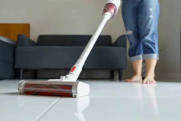 Maid cleaning the house, mop the floor, vacuum using a handheld vacuum cleaner. Eliminate germs and viruses Prevent infection from touching the concept of cleaning the house, housework