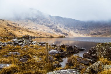 Güzel İrlandalı dağ manzarası ile bahar bir göl. Gleninchaquin park İrlanda.