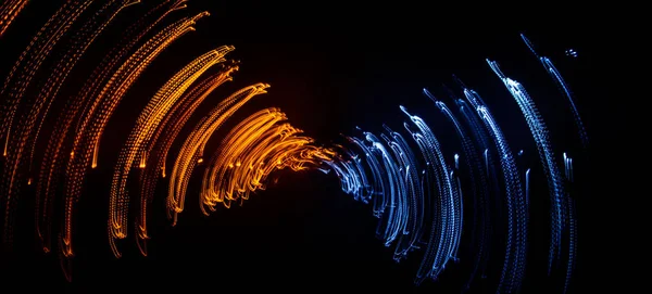 Colorful abstract trails of light. Dots, lines and bokeh on dark background. Long exposure.