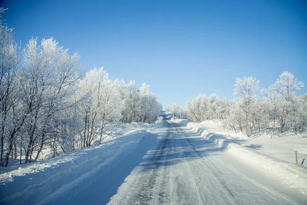 stock image A beautiful landscape with a white road in the Norwegian winter