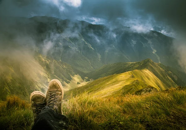A traveller resting in a mountain landscape in Carpathian mountains, Romania