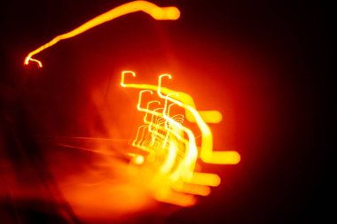 Işık koyu arka plan üzerinde kırmızı soyut yollar. Uzun pozlama.