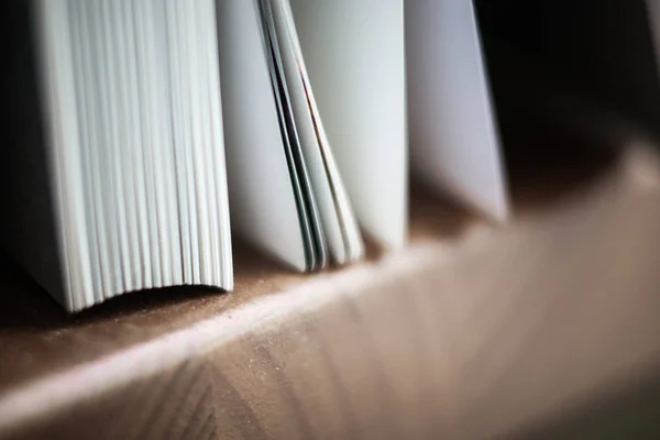 A beautiful closeup of a book in dark red cover and with red bookmark. Shallow depth of field — Stock Photo, Image