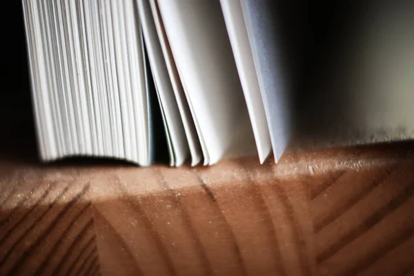 A beautiful closeup of a book in dark red cover and with red bookmark. Shallow depth of field — Stock Photo, Image