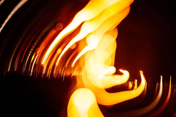 Red abstract trails of light on dark background. Long exposure. — Stock Photo, Image