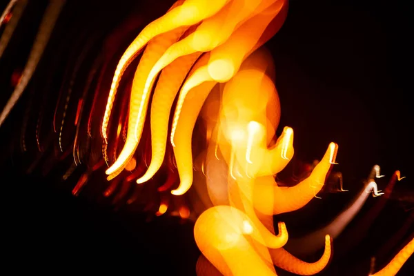 Red abstract trails of light on dark background. Long exposure. — Stock Photo, Image