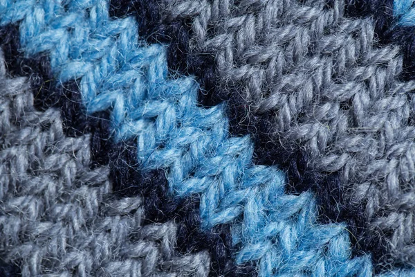 Een mooie close-up van een hand gebreide warm en zachte wol patroon. Zachte sokken of sjaal van natuurlijke wol. Kleurrijke patroon. — Stockfoto