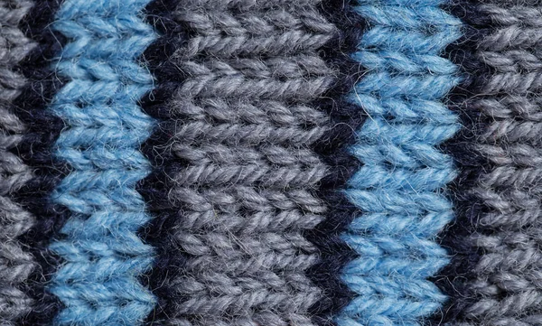 A beautiful closeup of a hand knitted warm and soft wool pattern. Soft socks or scarf of natural wool. Colorful pattern. — Stock Photo, Image