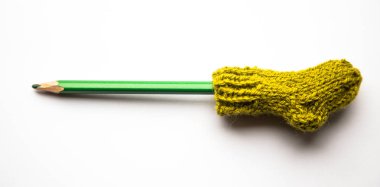 Küçük, örme Yün çorap ışık arka plan üzerinde renkli kalemler ile el