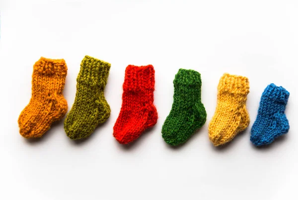 Small, hand knitted woolen socks on light background — Stock Photo, Image