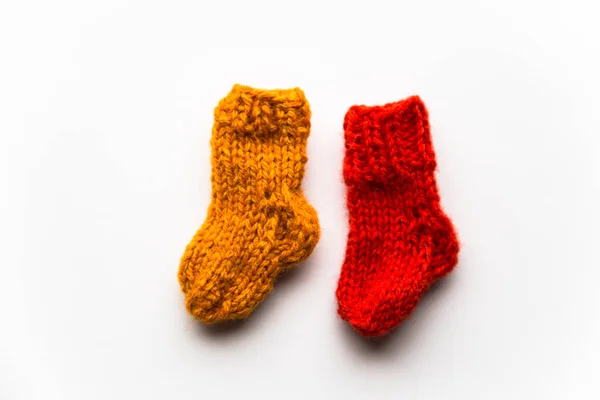 Small, hand knitted woolen socks on light background — Stock Photo, Image