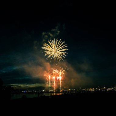 Güzel, renkli havai fişek yukarıda bir Bağımsızlık günü sırasında Nehri Riga, Letonya.