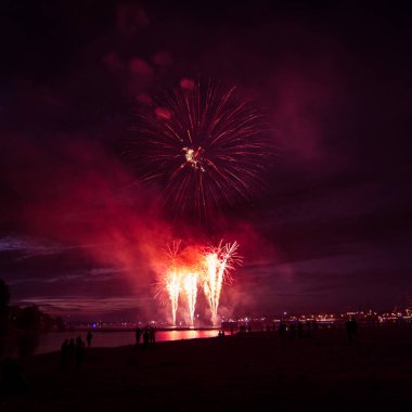 Güzel, renkli havai fişek yukarıda bir Bağımsızlık günü sırasında Nehri Riga, Letonya.