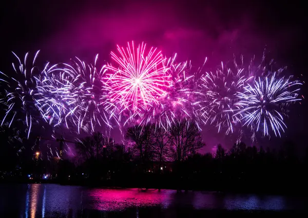 Beaux feux d'artifice colorés au-dessus de la rivière lors d'une journée de l'indépendance à Riga, Lettonie . — Photo