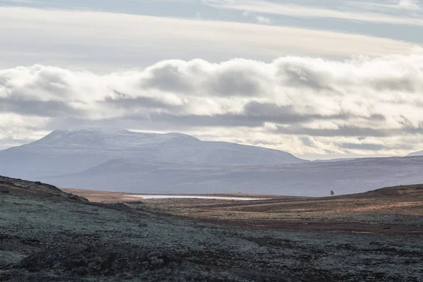 Uma bela paisagem montanhosa com um lago à distância. Montanhas de outono na Noruega. Cenário de queda na Escandinávia . — Fotografia de Stock