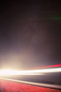 Güzel, soyut araba ışıklar bir ülke yolda. Geceyi, yol kenarında trafik. Uzun pozlama fotoğraf.