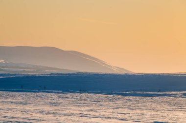 Güzel renkli kış günbatımı Merkez Norveç'te. Dağların üzerinden sıcak akşam ışığı.