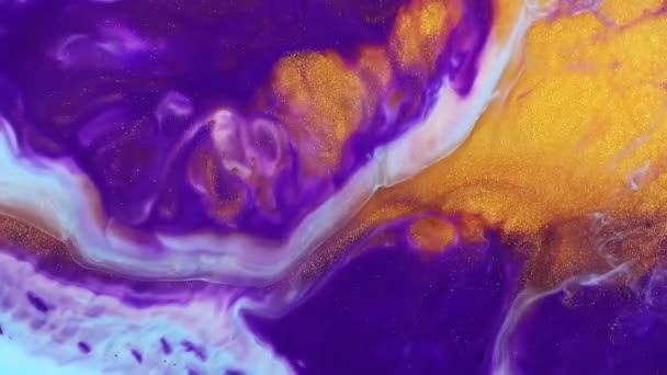 Fluid art slow motion. Abstract acrylic texture artwork. Fluid painting effect background. Mixed paint flow with vibrant swirling colors, close up view. Purple, gold and blue trend backdrop. — Stock Video