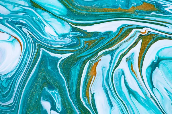 Fluid art texture. Abstract background with swirling paint effect. Liquid acrylic picture that flows and splashes. Mixed paints for background or poster. Blue, green and golden overflowing colors.