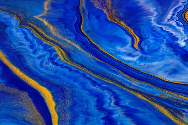 Fluid art texture. Abstract backdrop with iridescent paint effect. Liquid acrylic picture with flows and splashes. Classic blue color of the year 2020. Blue, golden and white overflowing colors.