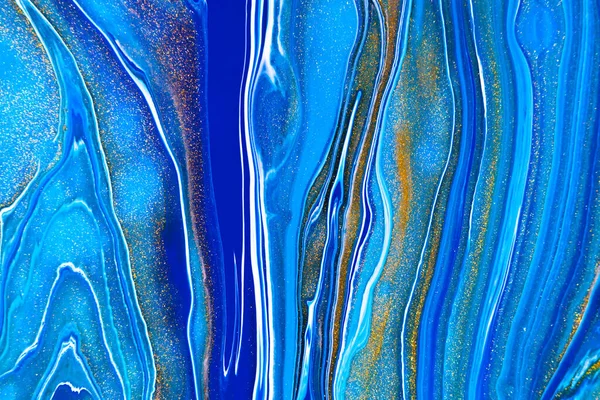 Fluid art texture. Background with abstract mixing paint effect. Liquid acrylic artwork that flows and splashes. Mixed paints for website background. Navy blue, golden and azure overflowing colors.