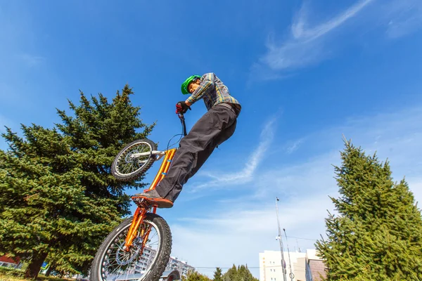 rider making tricks on bmx bicycle on the street