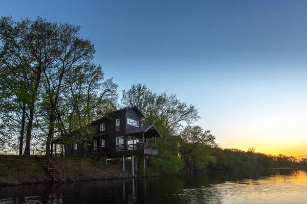 Contemporary wooden single family house. Retreat rental. Perfect getaway. Wooden house on a island with oaks. organic architecture. Wooden minimalistic house with big panoramic windows.