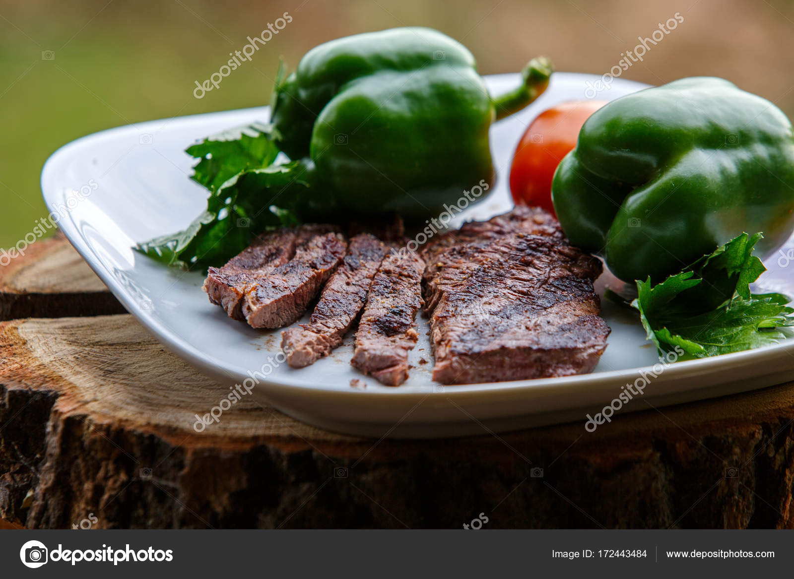 Grilled Beef Steak Chopped On White Plate Decorated With Organic