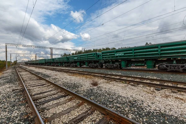 Old railway freight trains. Old rusty train station on a beautiful sunny day with amazing blue sky and white clouds.