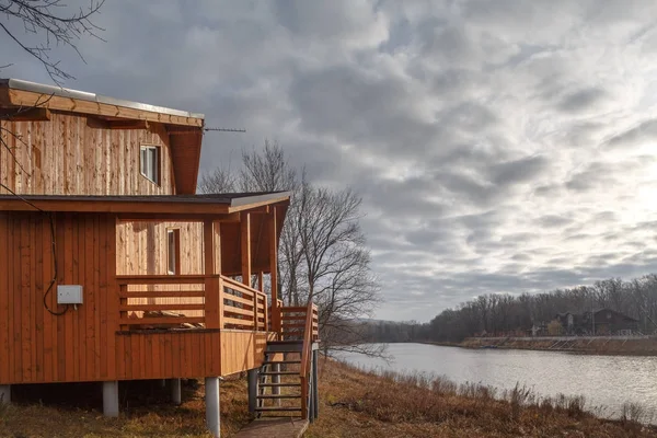 Contemporary wooden single family cottage on lake