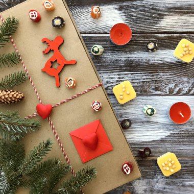 Kış düz lay ile romantik dekorasyon: hediye kutusu, mumlar, tatlılar ve köknar ahşap arka plan dallarda. Sevgililer günü kompozisyon, üstten görünüm. Aşk veya tebrik kavramı. 