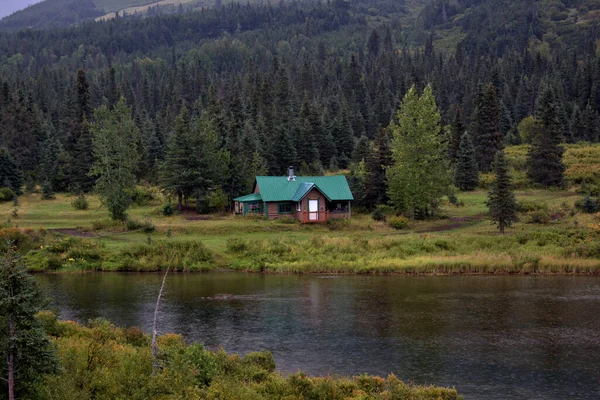 Alaskan cabin near a colorful lake