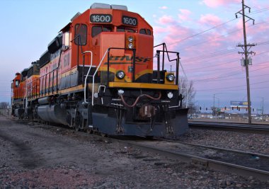  Early morning sunrise catches a colorful train engine on the siding