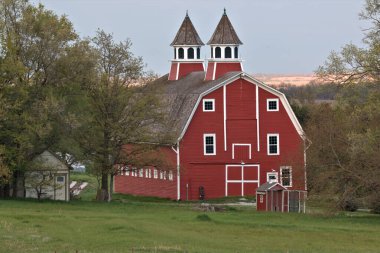 Granddaddy of all Barns proudly showing off its colors at sundown clipart