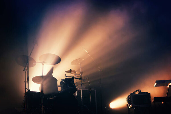 Drums on the stage, illuminated.
