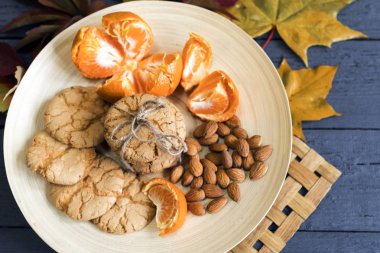 Sonbahar Reaply tarafından çevrili bir ahşap plaka üzerinde lezzetli Badem Çerezler