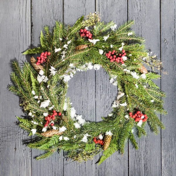 Christmas wreath of fir on a wooden background — Stock Photo, Image