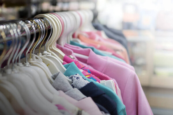 clothes hanging on a hanger in a store